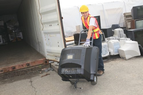 People segregating recyclable materials in a skip